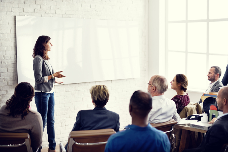 Professionals collaborating during a training session in a corporate office